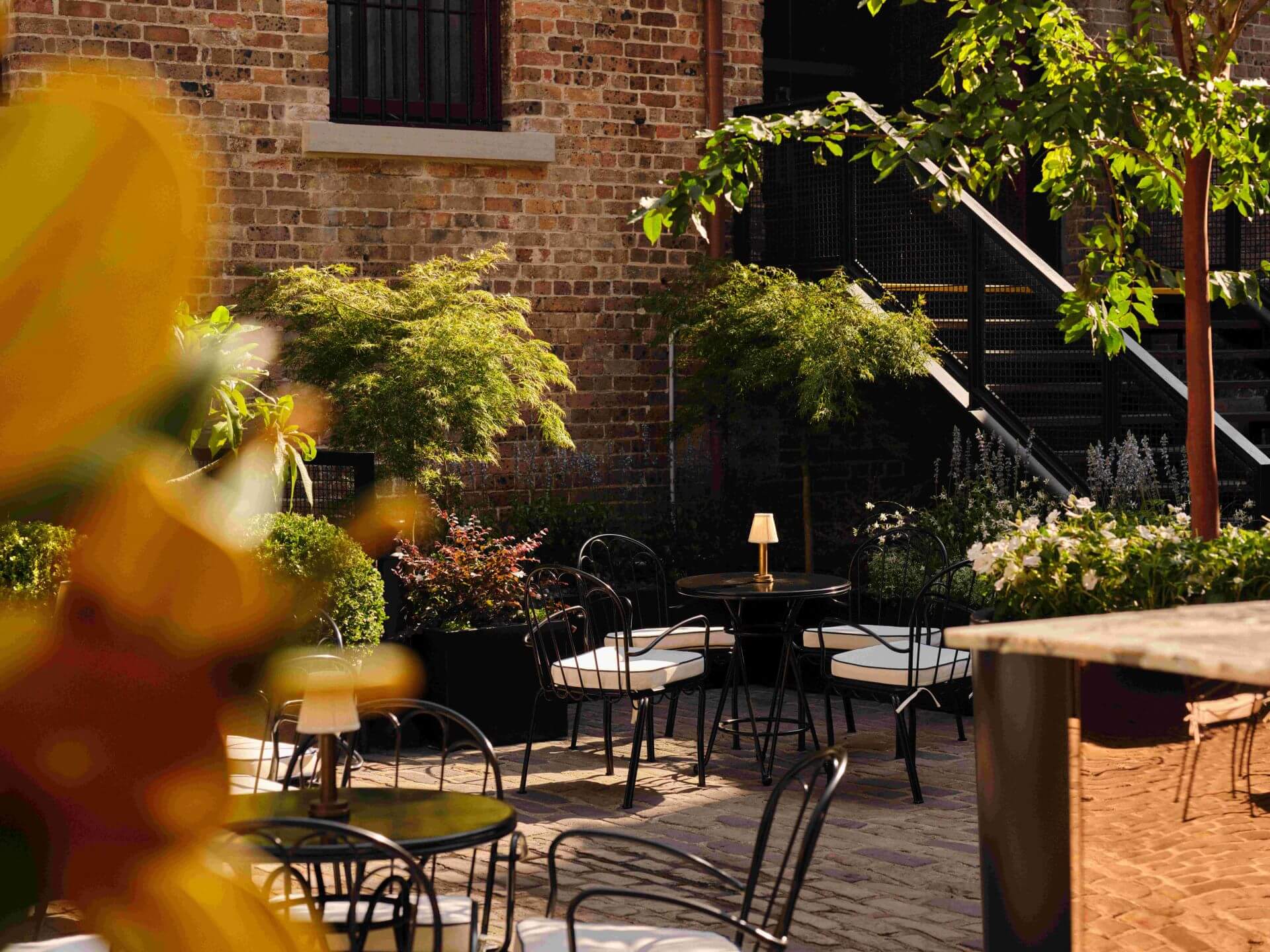 The Garden courtyard beside heritage brick in The Rocks